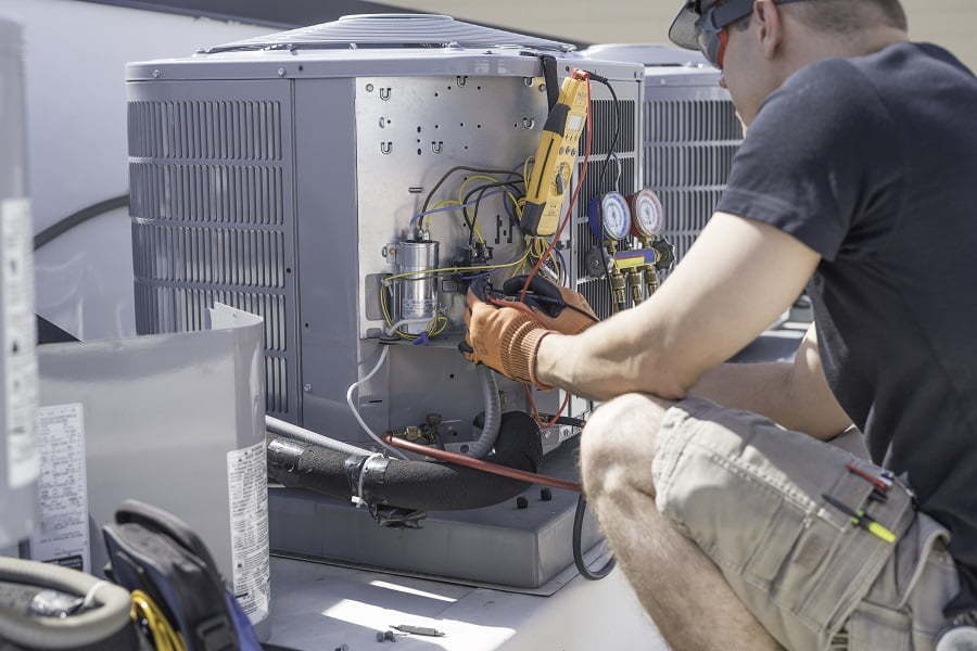 Comfort Air technician servicing a residential condenser unit